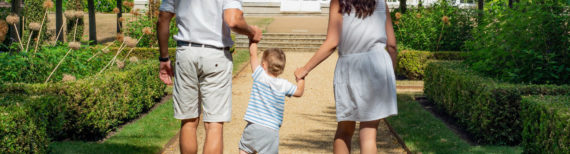 Photo of a couple holding their child's hands | Featured Image for Insurance Page by Approved Finance.