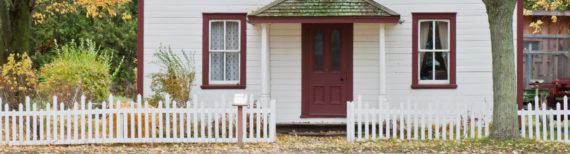 Photo of the front of a small white house | Featured Image for Home Loans Page by Approved Finance.